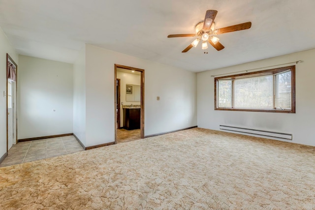 unfurnished bedroom featuring light carpet, ensuite bathroom, baseboard heating, and ceiling fan