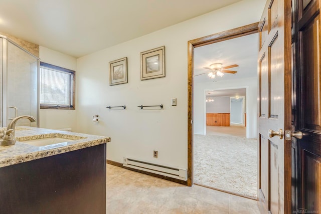 bathroom with ceiling fan, vanity, and a baseboard radiator