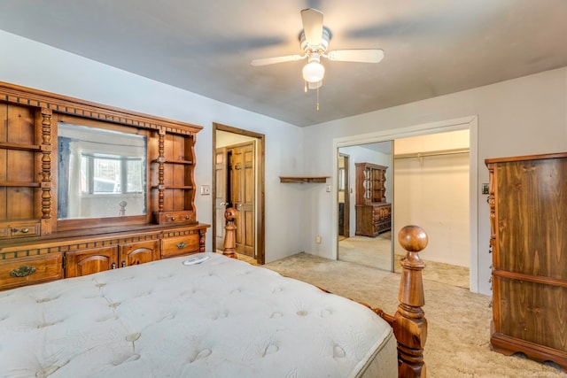 carpeted bedroom featuring ceiling fan and a closet