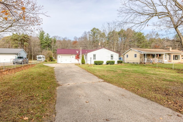 view of front of property featuring a front lawn, covered porch, and a garage