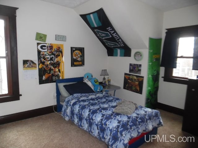 carpeted bedroom with vaulted ceiling