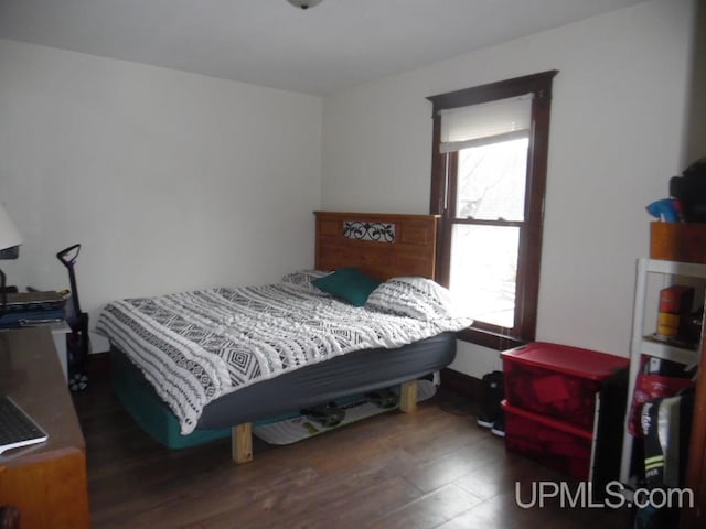 bedroom featuring dark hardwood / wood-style flooring