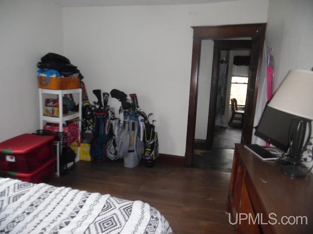 bedroom with dark hardwood / wood-style floors