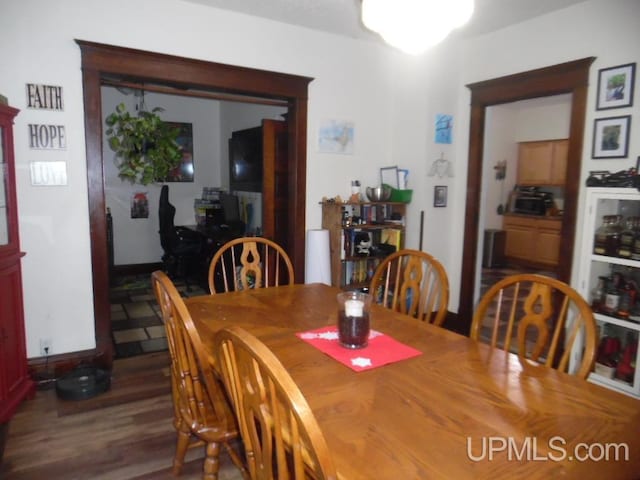 dining area featuring dark hardwood / wood-style floors