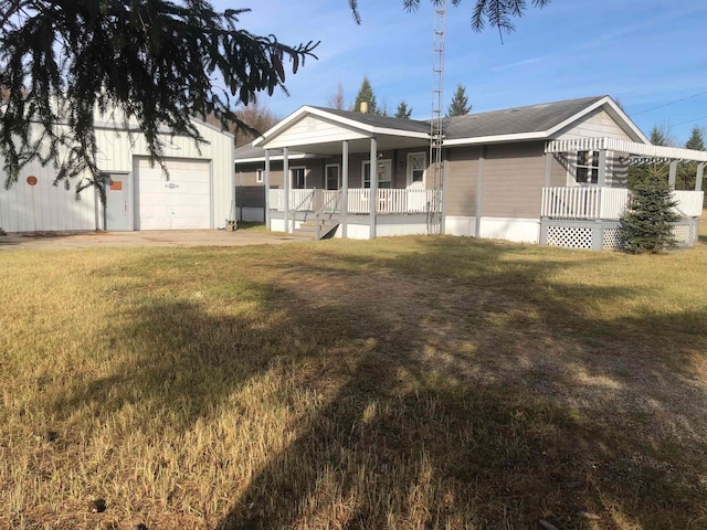 view of front of home featuring a garage, covered porch, an outdoor structure, and a front yard