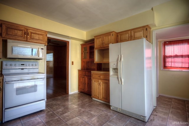 kitchen featuring white appliances, tile patterned floors, and ceiling fan