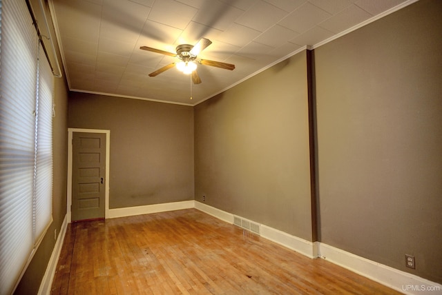 spare room with crown molding, ceiling fan, and light wood-type flooring