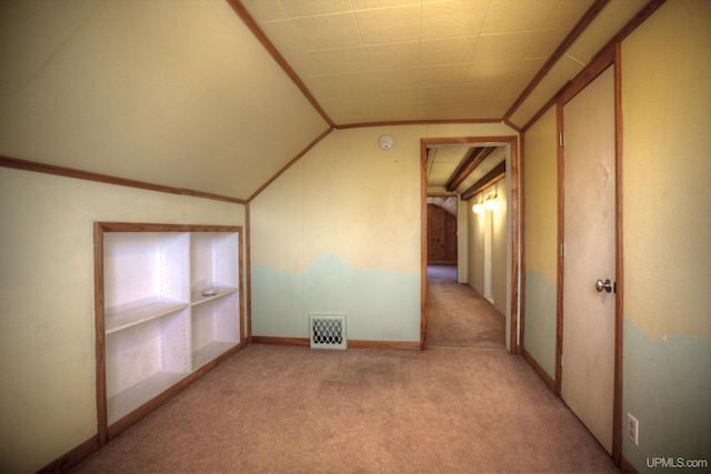 bonus room with light colored carpet and lofted ceiling