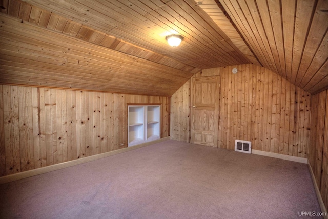 additional living space featuring carpet flooring, built in shelves, wood walls, lofted ceiling, and wood ceiling