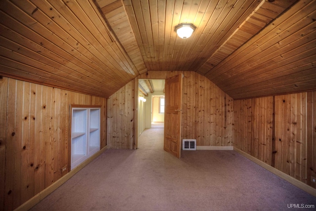 bonus room with carpet flooring, lofted ceiling, wood ceiling, and wooden walls