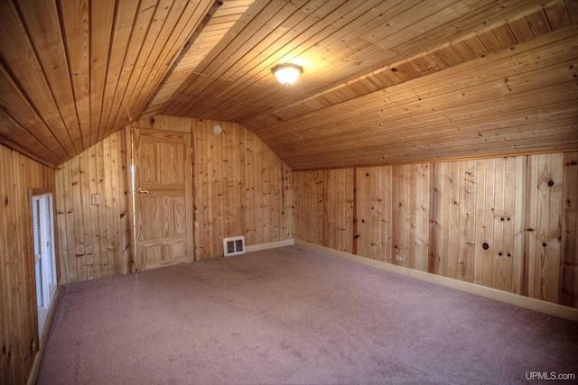 additional living space featuring carpet flooring, lofted ceiling, wooden ceiling, and wood walls