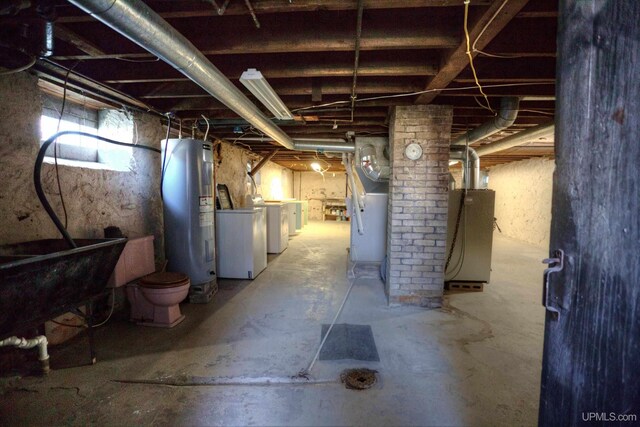 basement featuring washer and clothes dryer and electric water heater