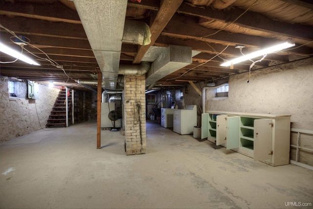 basement featuring washing machine and dryer and heating unit