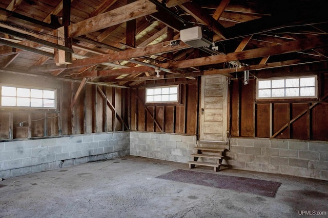 miscellaneous room with concrete floors, plenty of natural light, and lofted ceiling