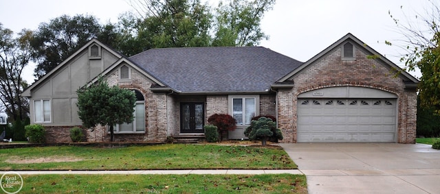 view of front of home with a garage and a front lawn