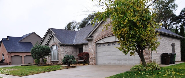 view of front of home featuring a front yard and a garage