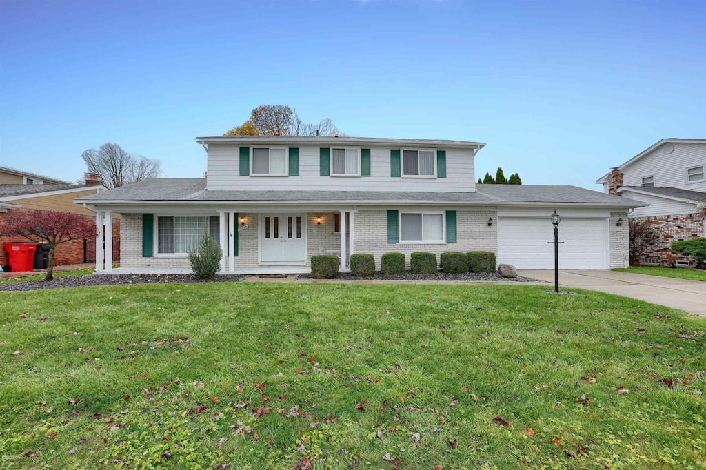 view of front property with a garage and a front lawn