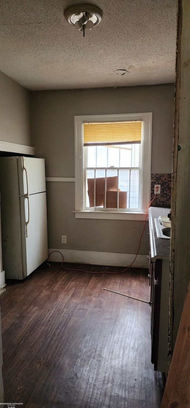 9534 Littlefield St, Detroit, MI 48227 - kitchen with freestanding refrigerator, dark wood-type flooring, a sink, a textured ceiling, and dark countertops
