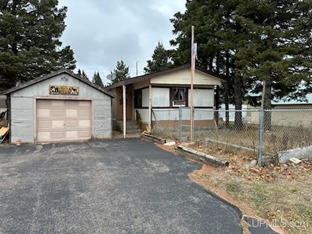 view of front facade with an outbuilding and a garage