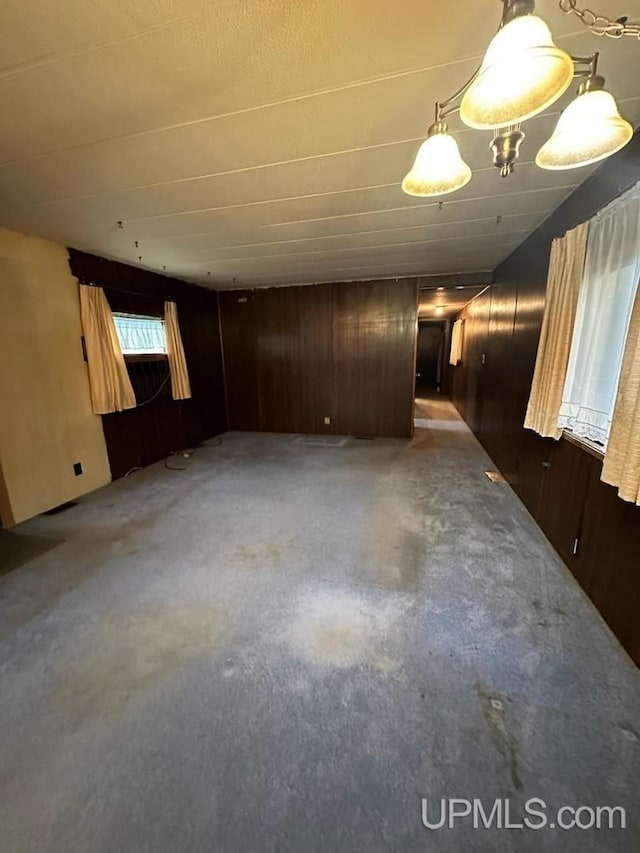 spare room featuring wooden walls