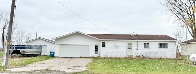 back of property featuring a yard and a garage