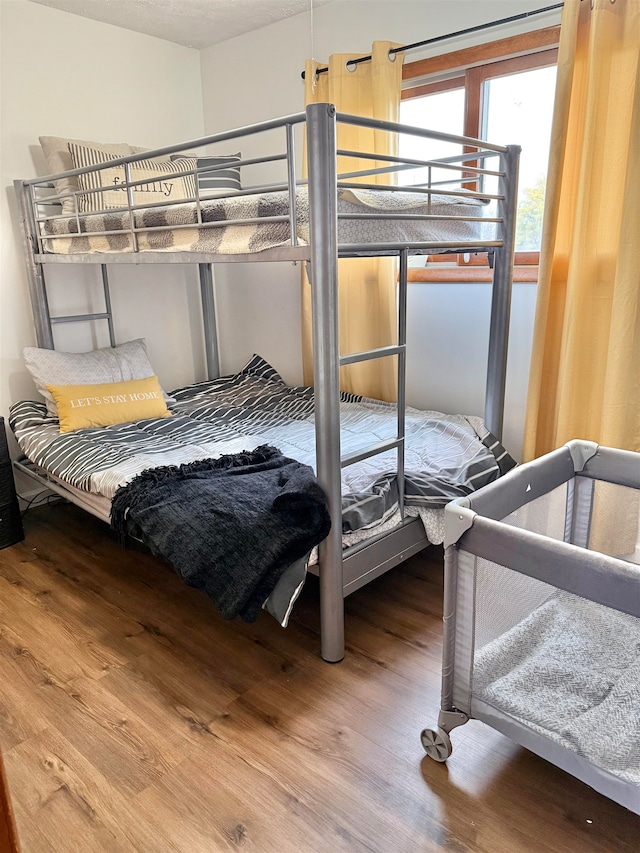 bedroom with wood-type flooring