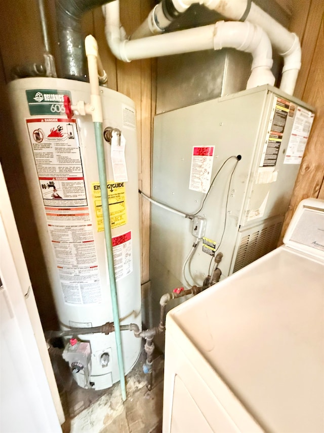 utilities featuring gas water heater and washer / clothes dryer