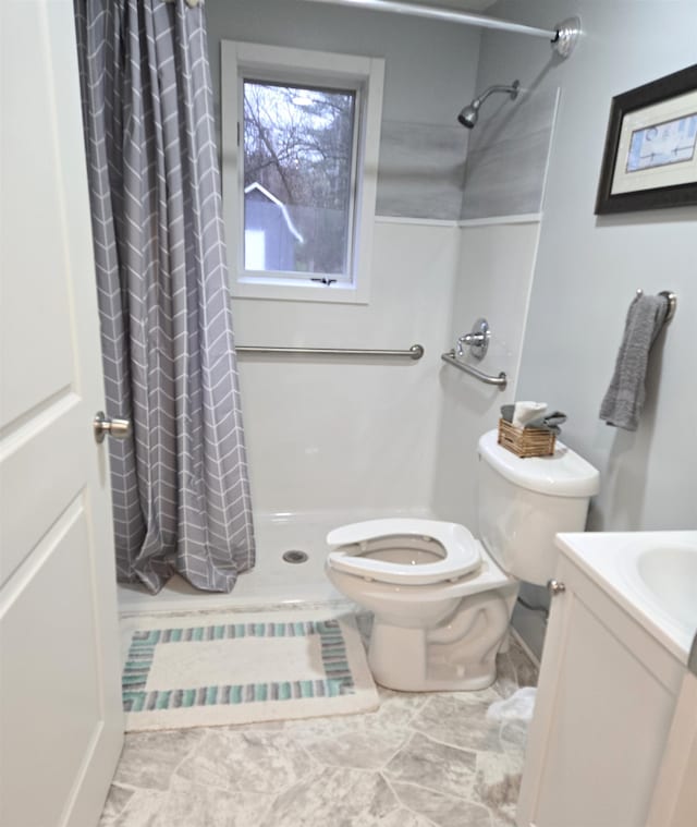 bathroom featuring tile patterned flooring, a shower with curtain, vanity, and toilet