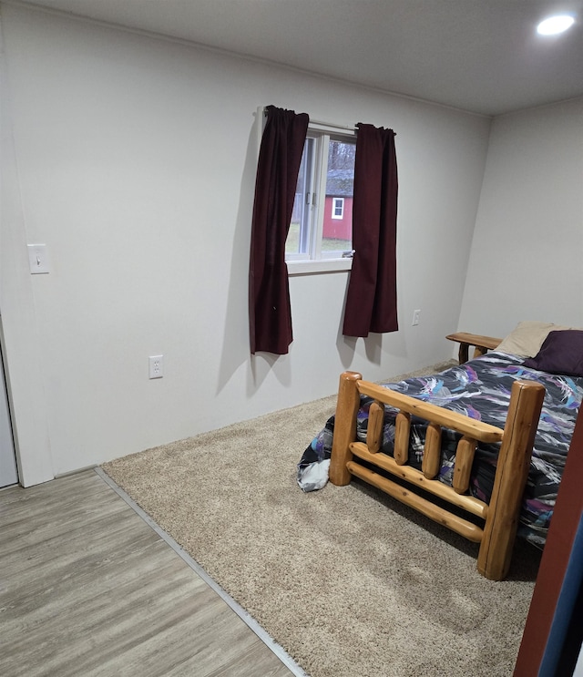 bedroom with wood-type flooring