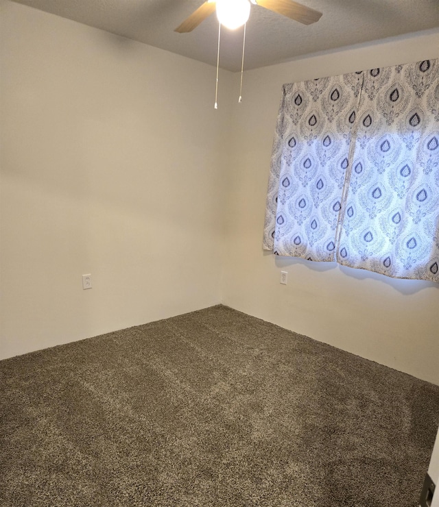 spare room featuring carpet flooring and ceiling fan