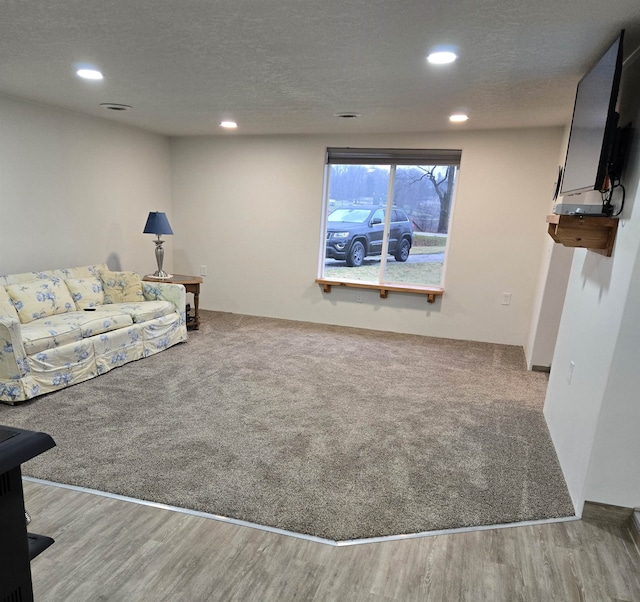 living room with light hardwood / wood-style floors and a textured ceiling