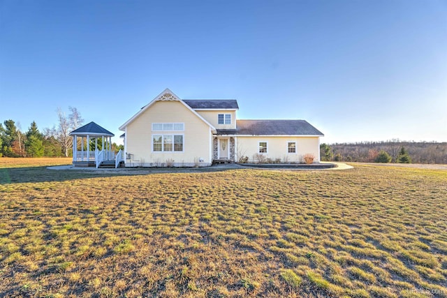 view of front of home with a gazebo and a front lawn