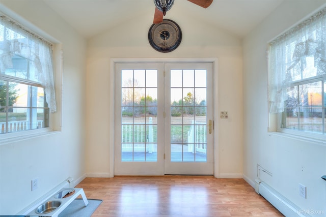 doorway to outside featuring french doors, light wood-type flooring, vaulted ceiling, baseboard heating, and ceiling fan