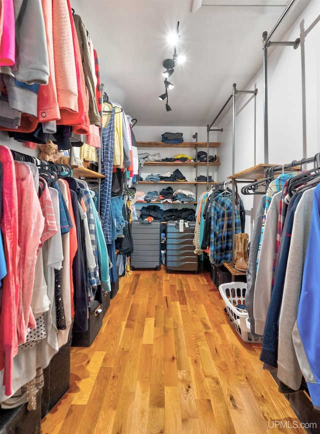 spacious closet with light hardwood / wood-style floors