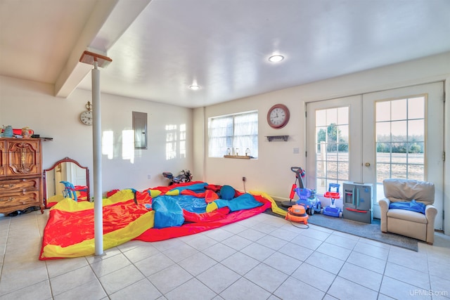 recreation room with light tile patterned floors, electric panel, and french doors