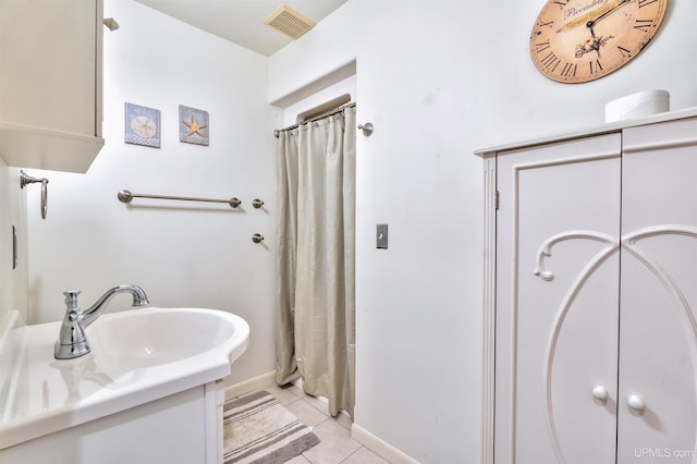 bathroom with tile patterned flooring, vanity, and curtained shower