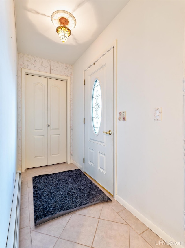 entrance foyer with light tile patterned floors and a baseboard radiator