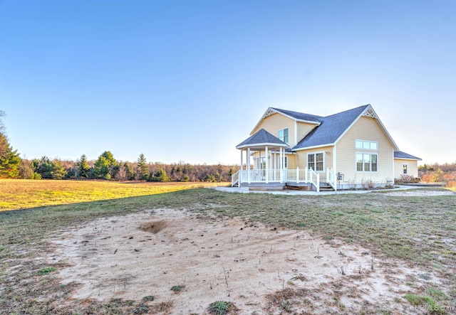 view of front of property with a porch and a front yard