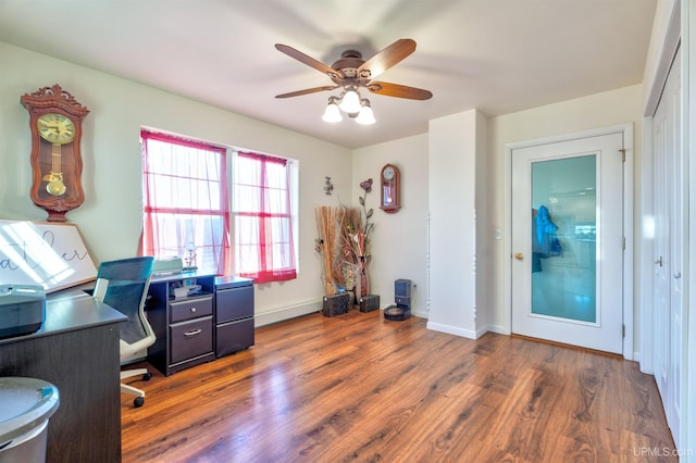 office area with ceiling fan and dark wood-type flooring