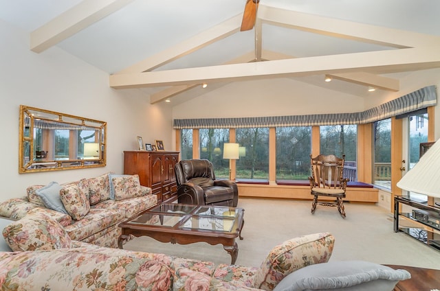 carpeted living room with beamed ceiling and high vaulted ceiling