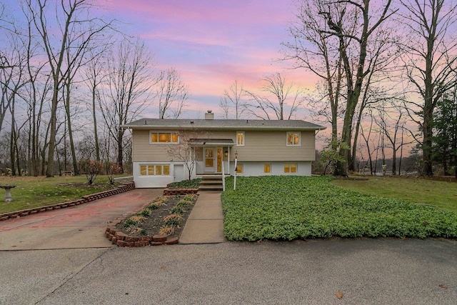 raised ranch with a lawn