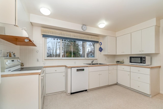 kitchen featuring white cabinetry, sink, white appliances, and backsplash