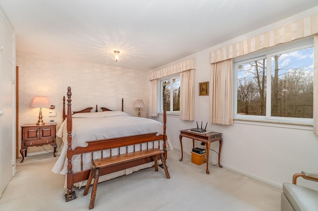 bedroom with multiple windows and light colored carpet