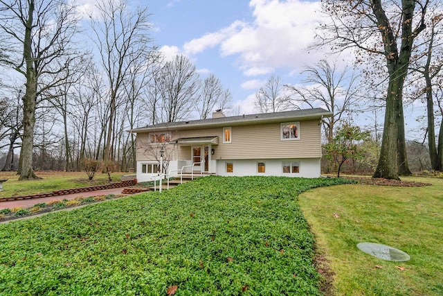 raised ranch with a front yard