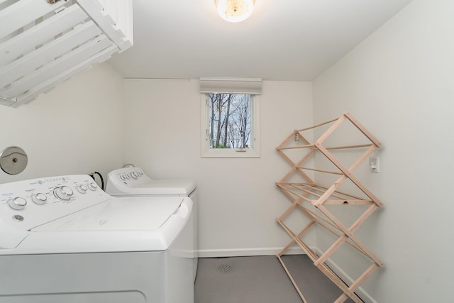 clothes washing area with washing machine and dryer