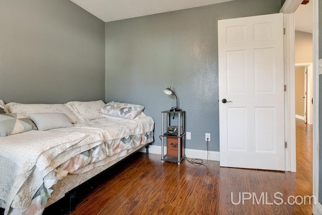 bedroom featuring dark hardwood / wood-style flooring