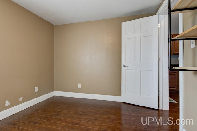 empty room with dark wood-type flooring