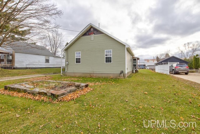 view of side of home with a yard