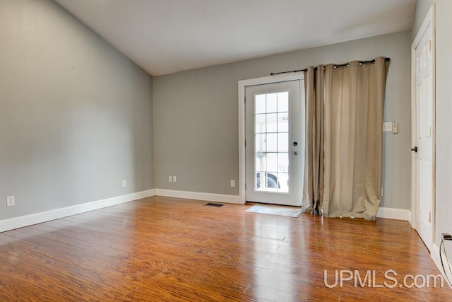 spare room with hardwood / wood-style floors