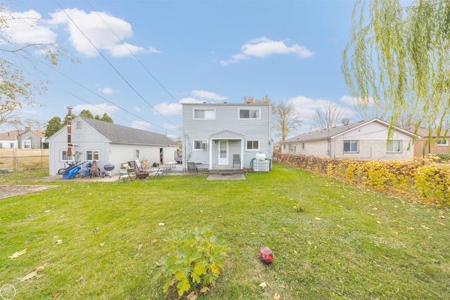 back of property featuring a lawn and a patio area